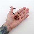 Handmade chainmail mini Halloween ornament, pumpkin orange, black, and purple seasonal dodecahedron decoration