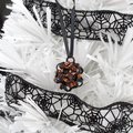 Chainmail Halloween ornament in black and orange with purple accents, handmade dodecahedron ball