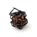 Chainmail Halloween ornament in black and orange with purple accents, handmade dodecahedron ball