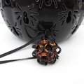 Chainmail Halloween ornament in black and orange with purple accents, handmade dodecahedron ball
