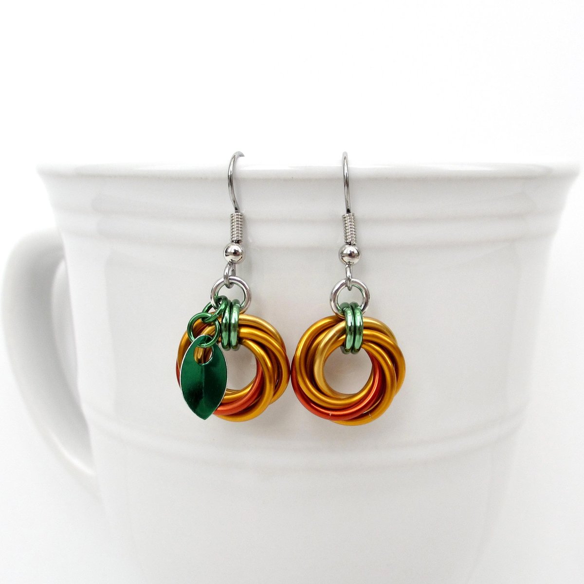 Small pumpkin earrings, fall jewelry with green leaf accent, handmade chainmail swirled knot -autumn, Halloween and Thanksgiving accessories
