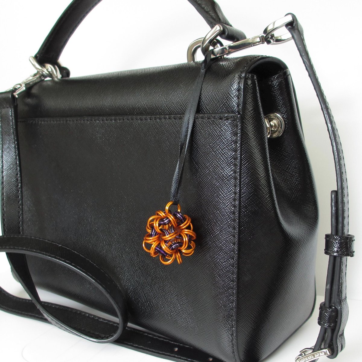 Handmade chainmail mini Halloween ornament, pumpkin orange, black, and purple seasonal dodecahedron decoration