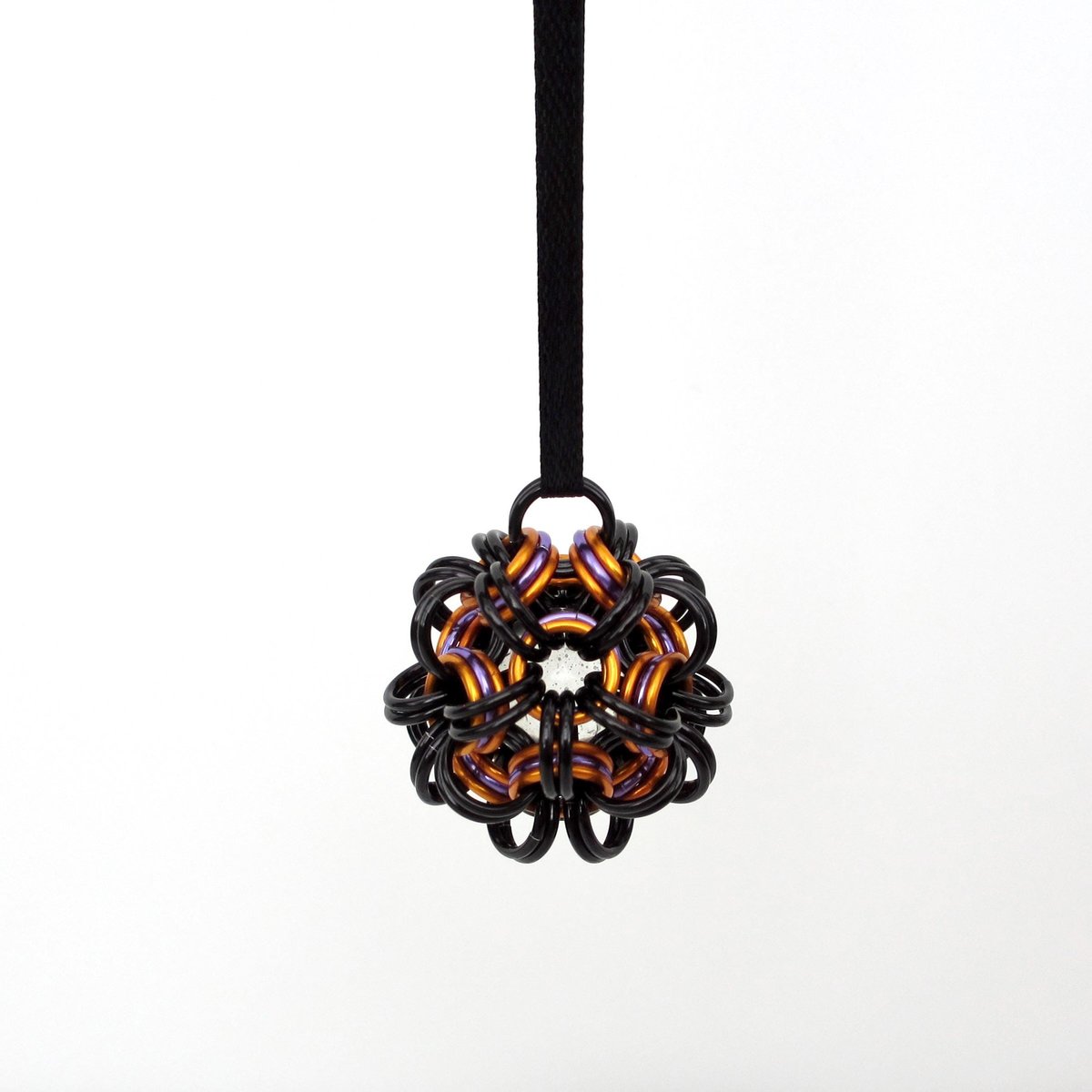 Chainmail Halloween ornament in black and orange with purple accents, handmade dodecahedron ball