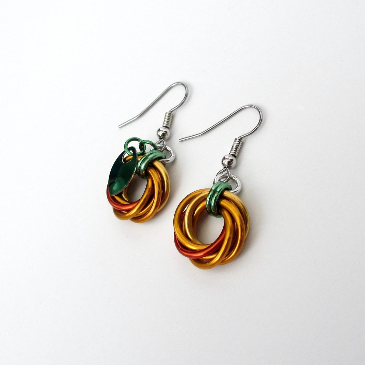 Small pumpkin earrings, fall jewelry with green leaf accent, handmade chainmail swirled knot -autumn, Halloween and Thanksgiving accessories