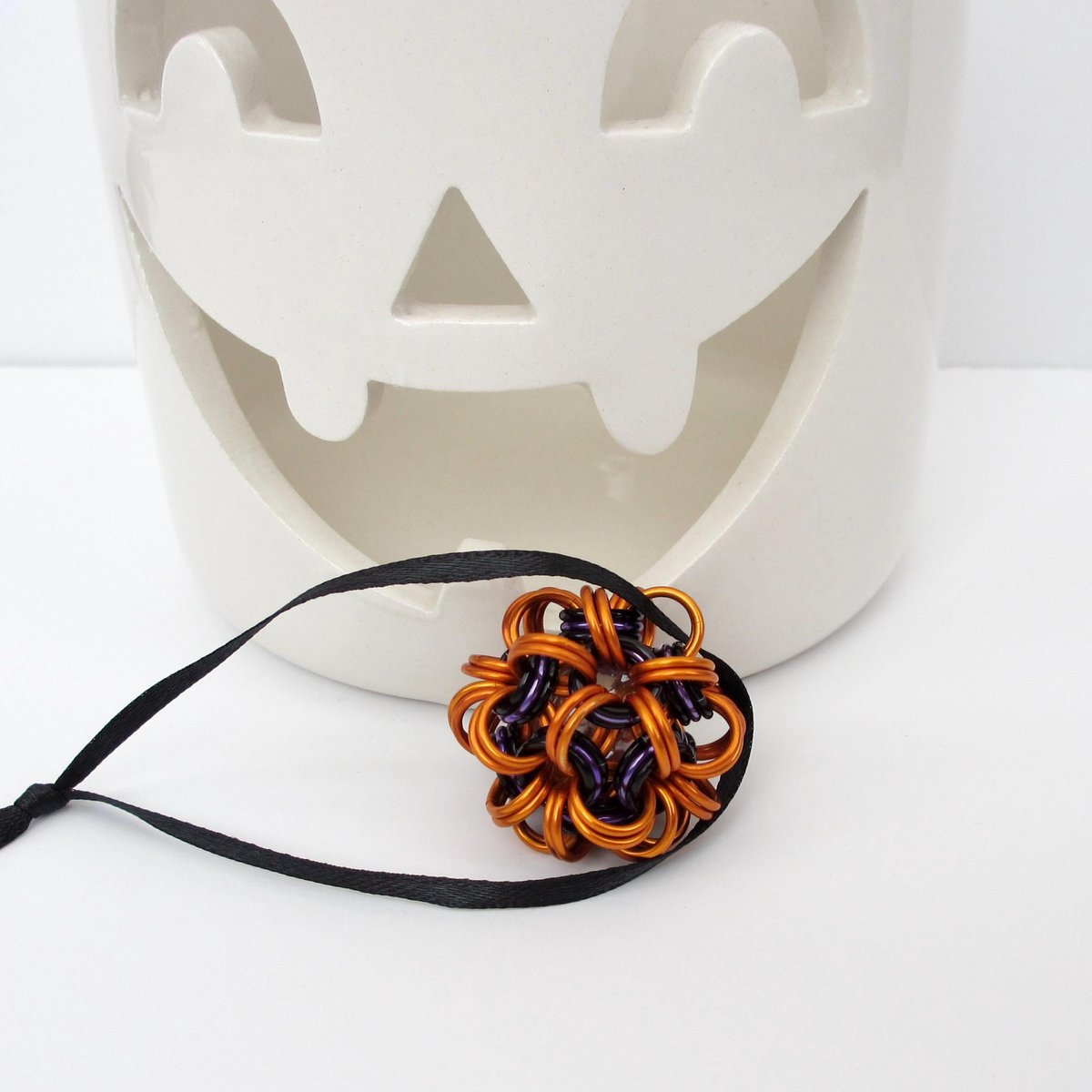Handmade chainmail mini Halloween ornament, pumpkin orange, black, and purple seasonal dodecahedron decoration