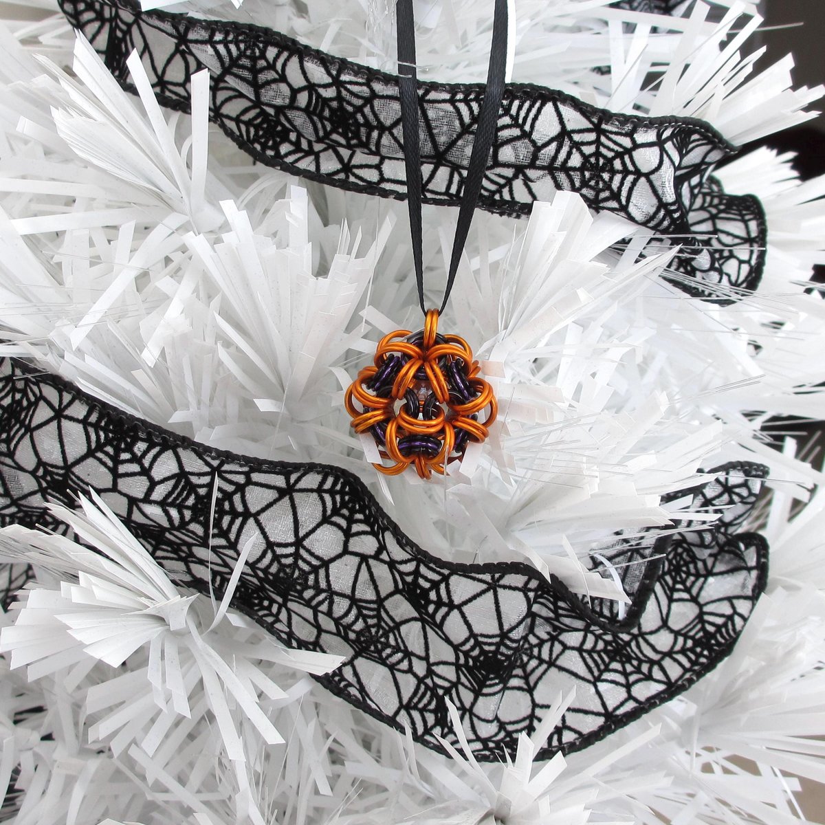 Handmade chainmail mini Halloween ornament, pumpkin orange, black, and purple seasonal dodecahedron decoration