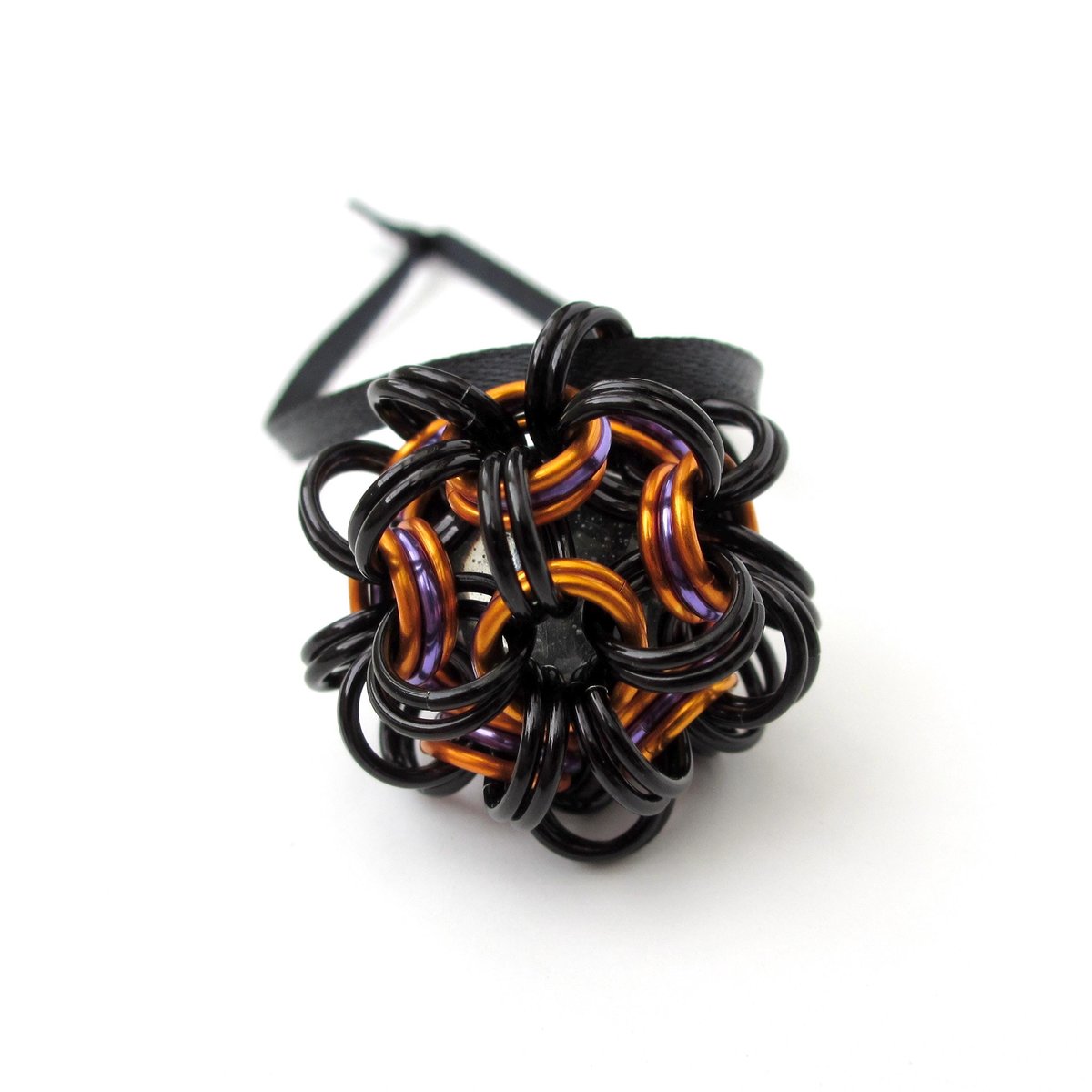 Chainmail Halloween ornament in black and orange with purple accents, handmade dodecahedron ball
